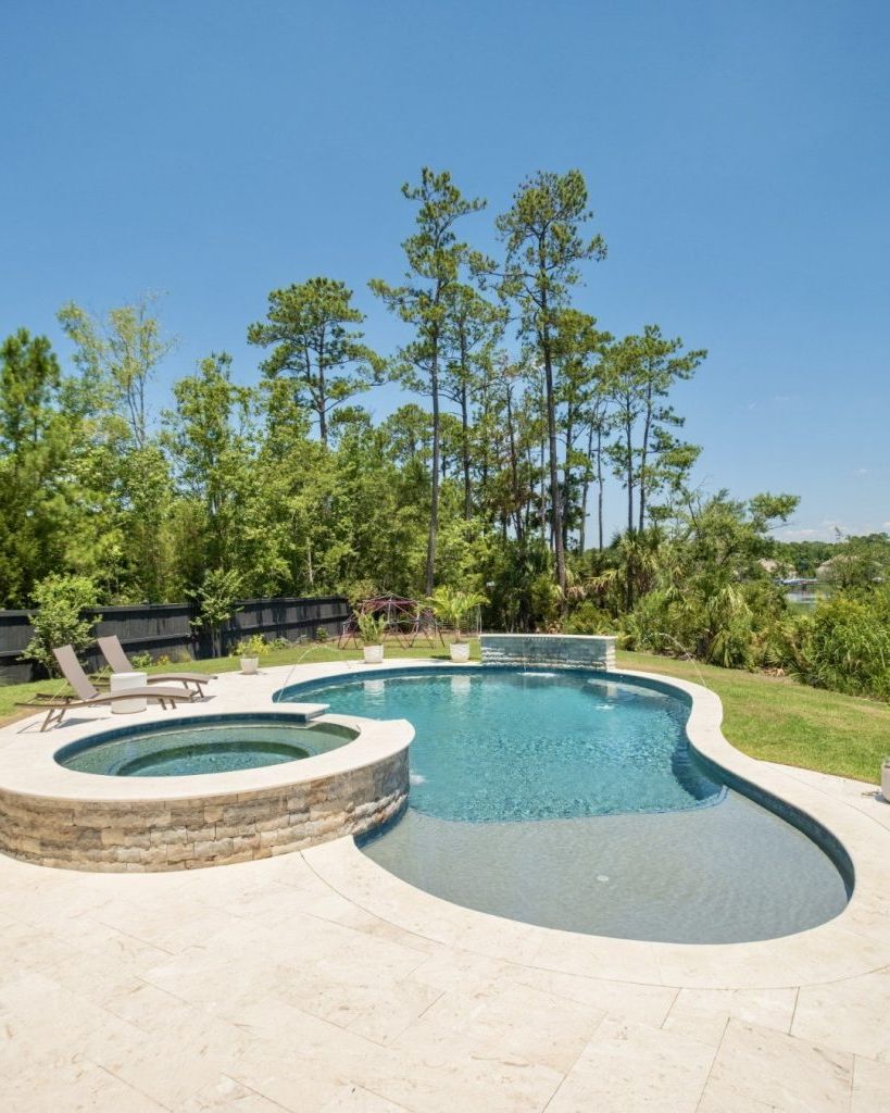 14. A Curved Pool With Built-In Spa
