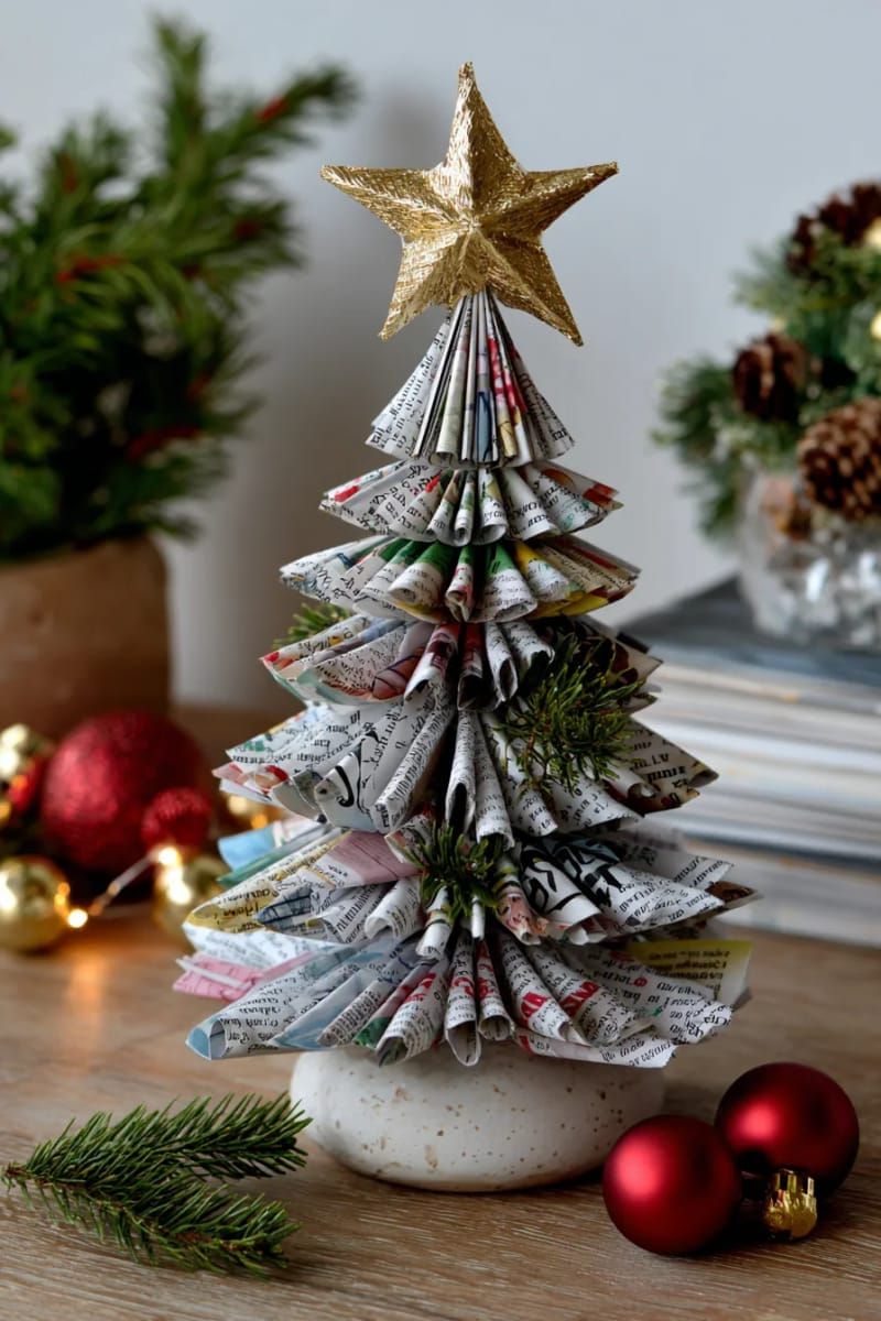 17. Magazine page tree sculpture featuring a gold star decoration on top - photo 3