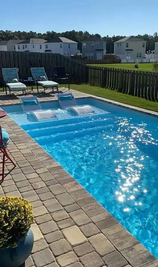 31. Relaxing Oasis: Stunning Pool with Stylish Paver Deck