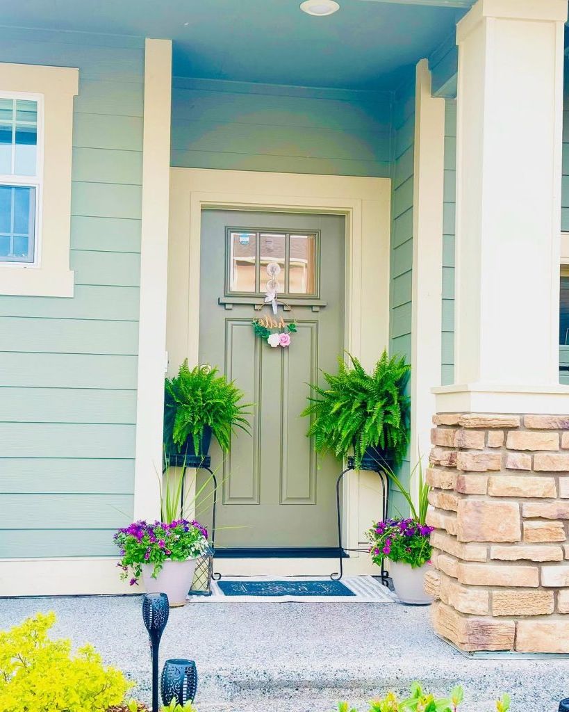 18. Fern and Flower Accents for a Welcoming Entry