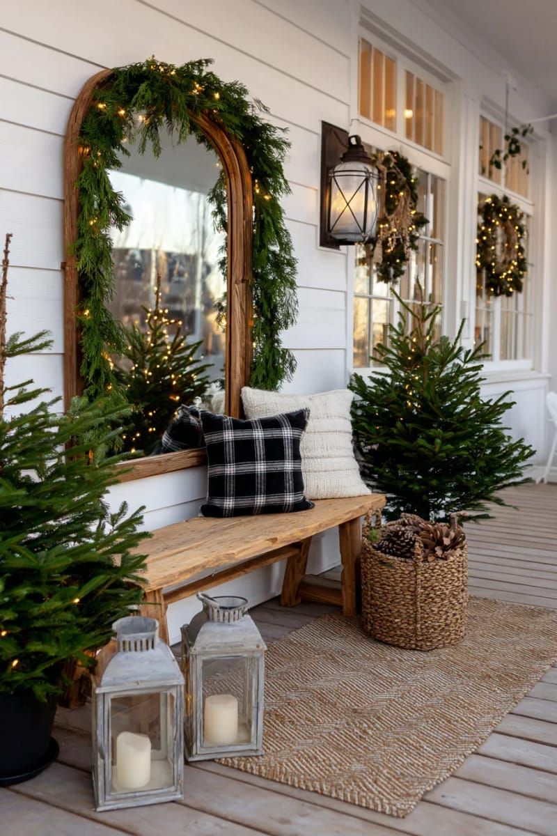 15. Garland-Wrapped Mirror and Chandelier Porch Display