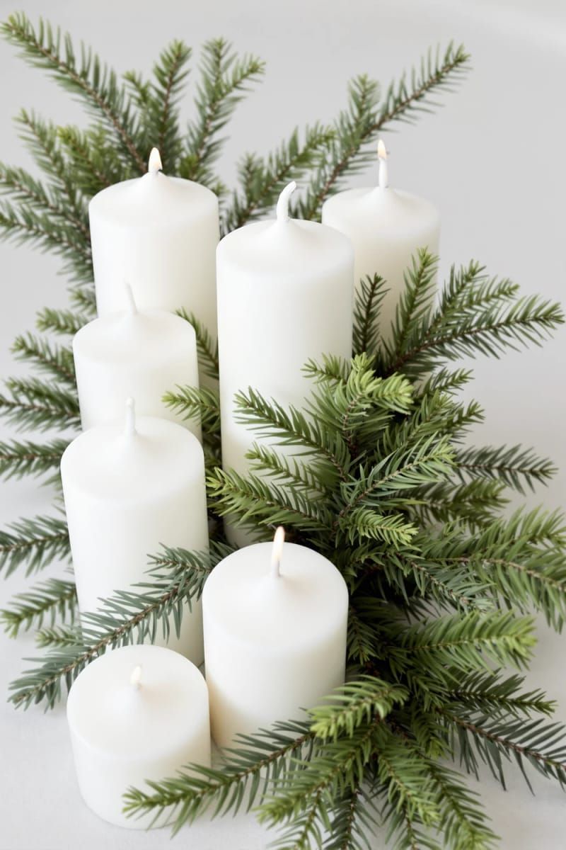 10. White Pillar Candles Grouped With Pine Sprigs - photo 2