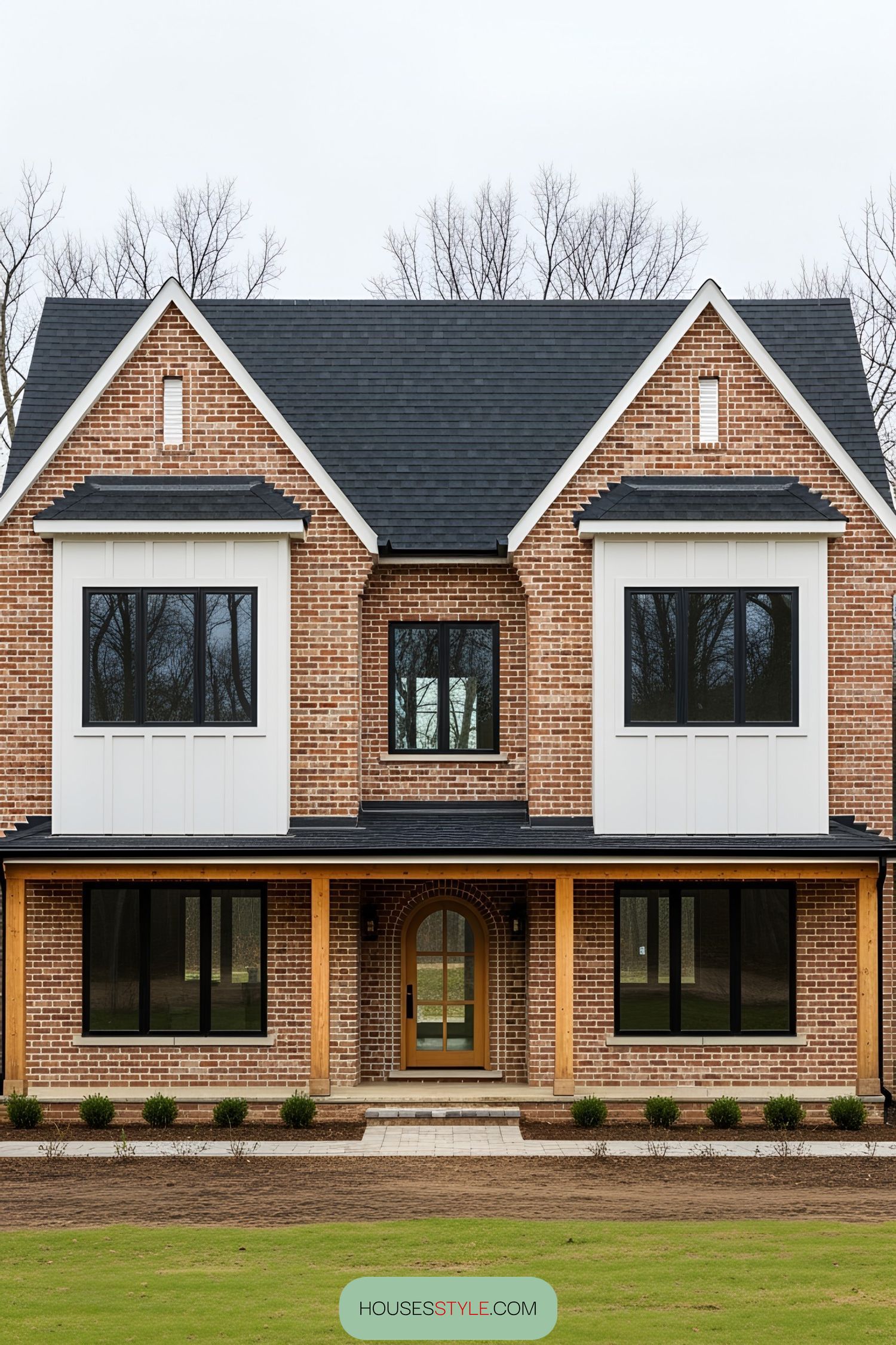 Brick Farmhouse Surrounded by Bare Winter Trees
