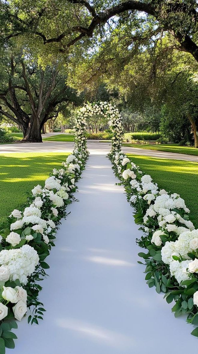 14. Flower-Bordered Ceremony Aisle With Greenery