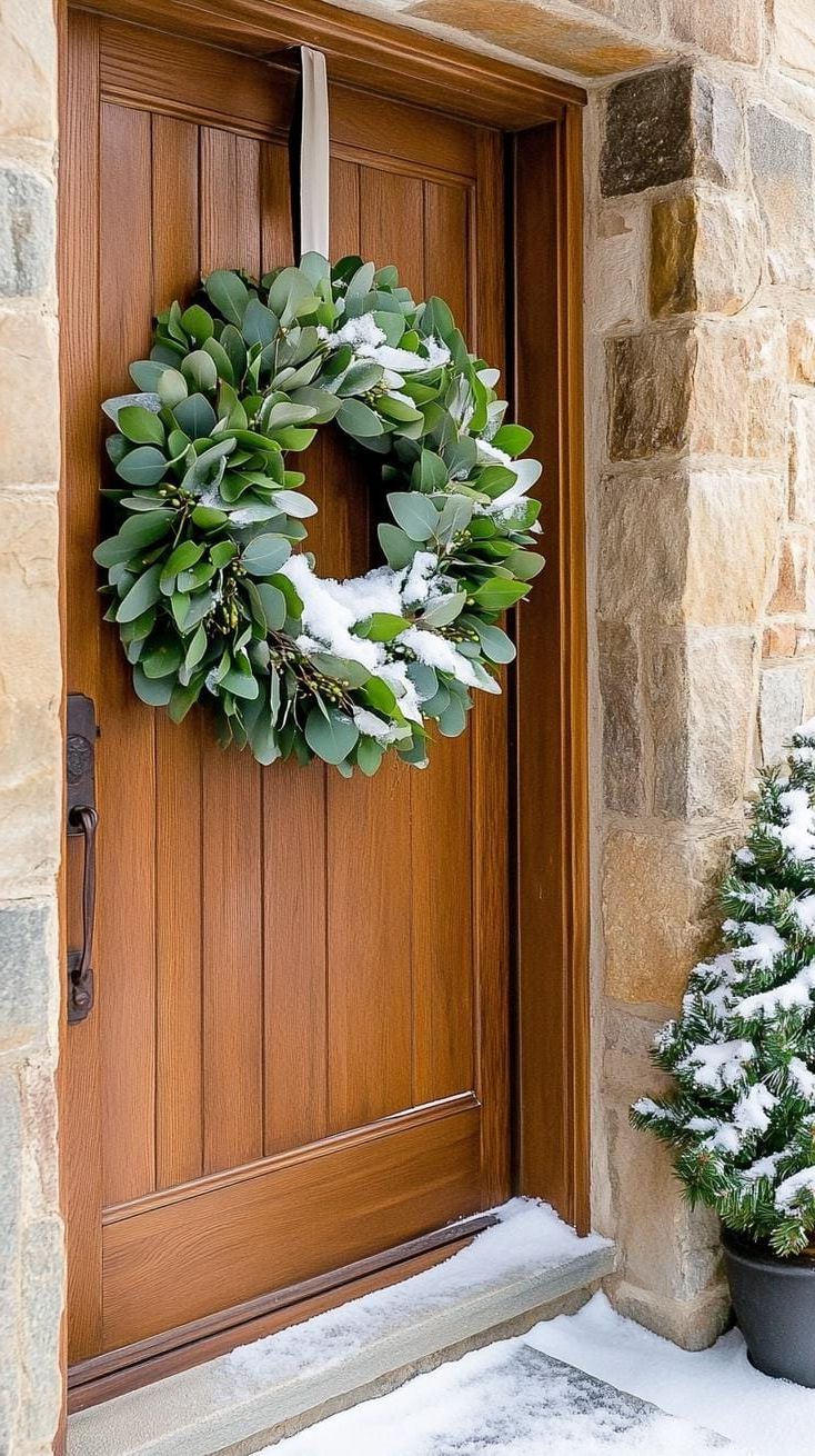 7. Snow-Dusted Eucalyptus Wreath on Wooden Door